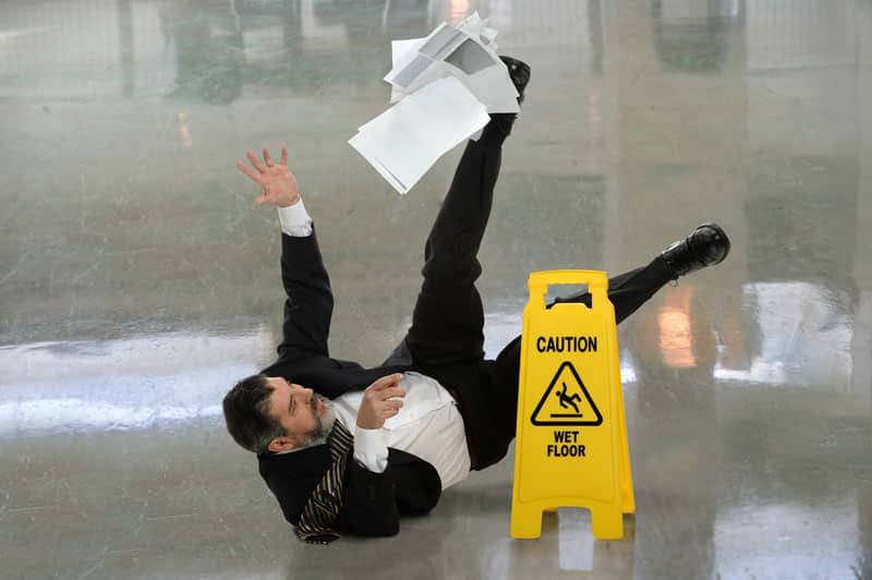 A man in a suit is on the ground