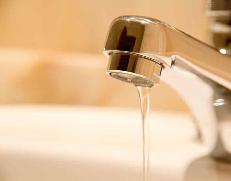 A faucet that is dripping water into the sink.