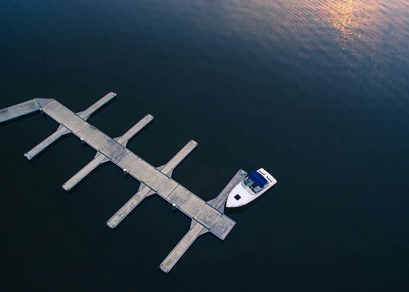 A boat is docked at the pier in the water.