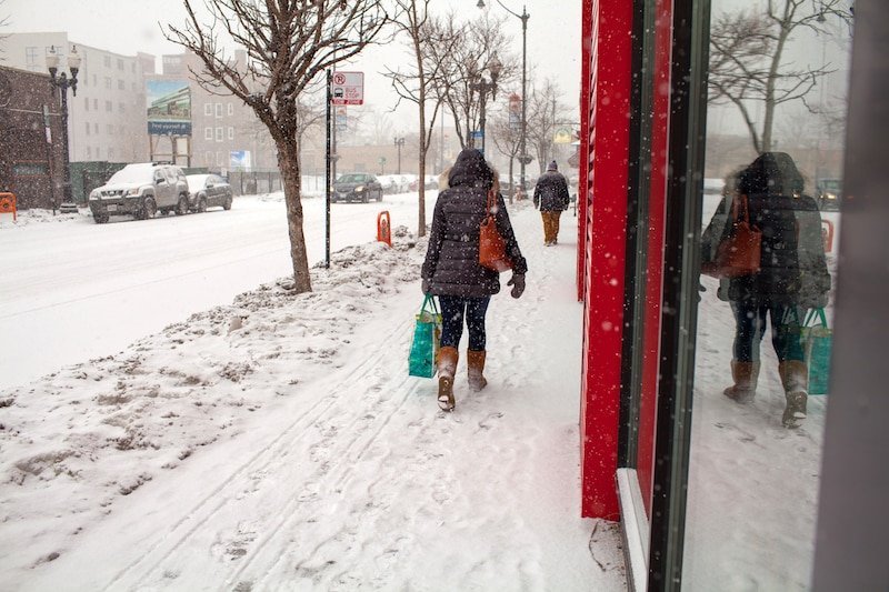 A woman walking down the street in winter.