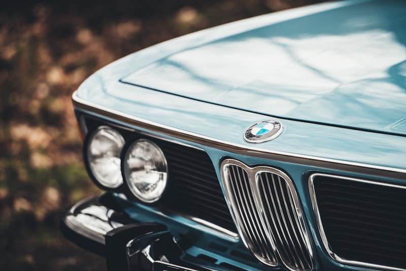 A close up of the front end of an old bmw car