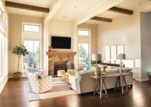 A living room with a fireplace and a flat screen tv.