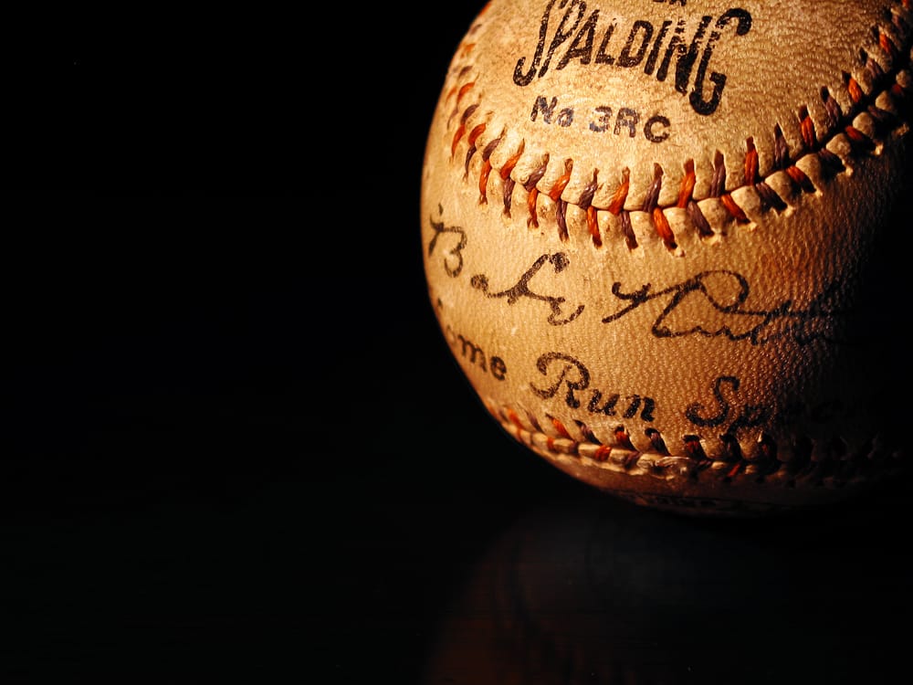 A baseball with the name of spalding no. 3 8 0 and the number 1 9 on it