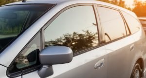 A car with its door open and the window opened.