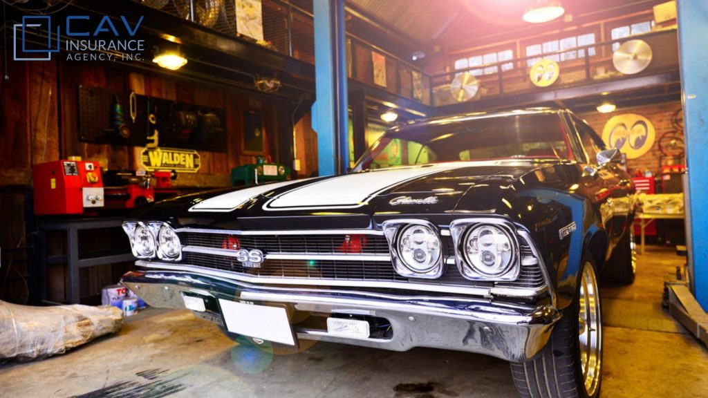 A black and white car in a garage