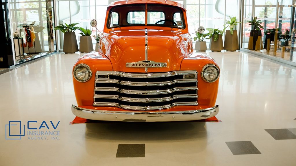 An orange truck is parked in a building.