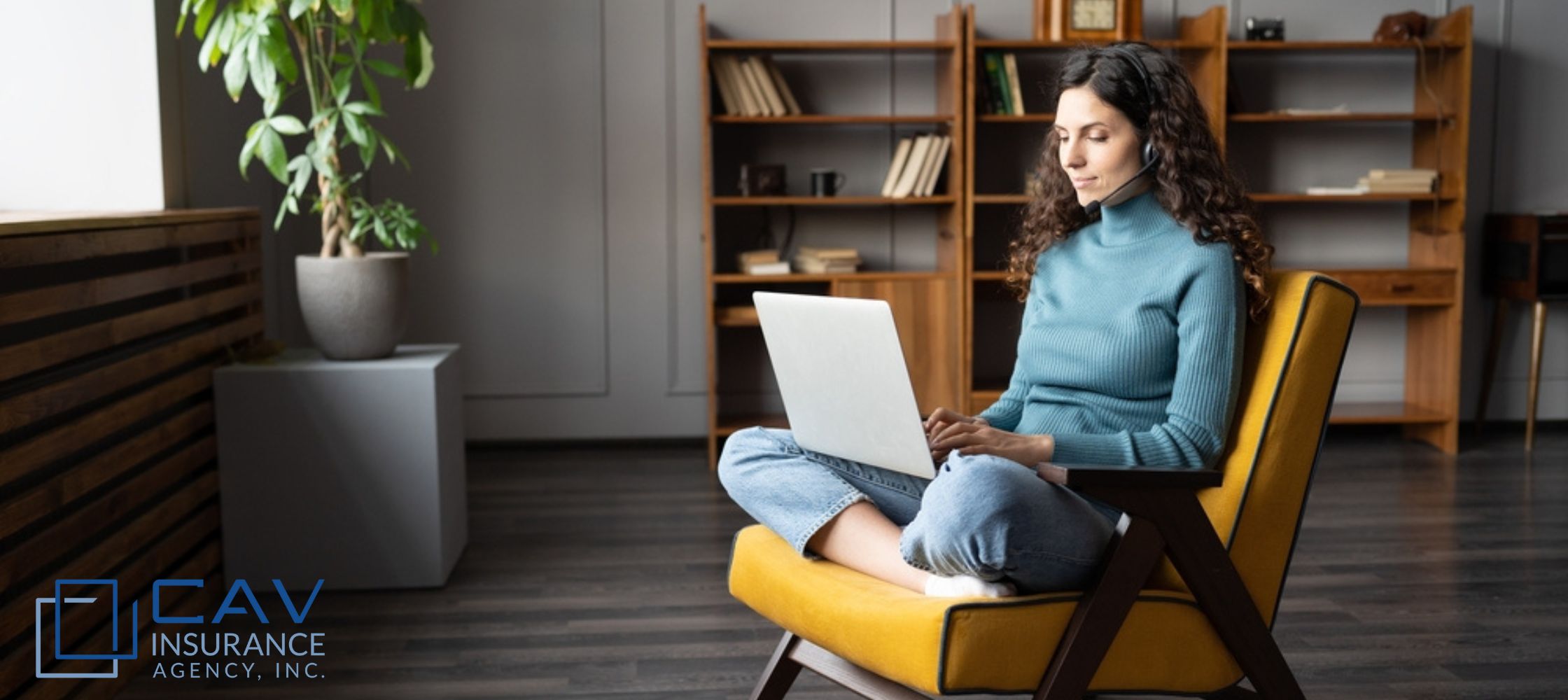 A woman sitting on top of a chair using her laptop.