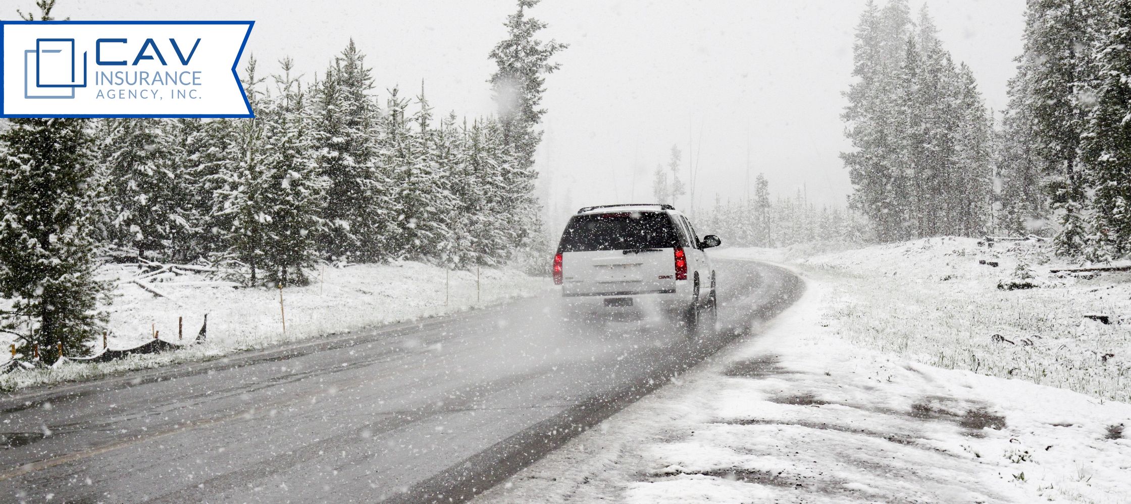 A car driving down the road in snow