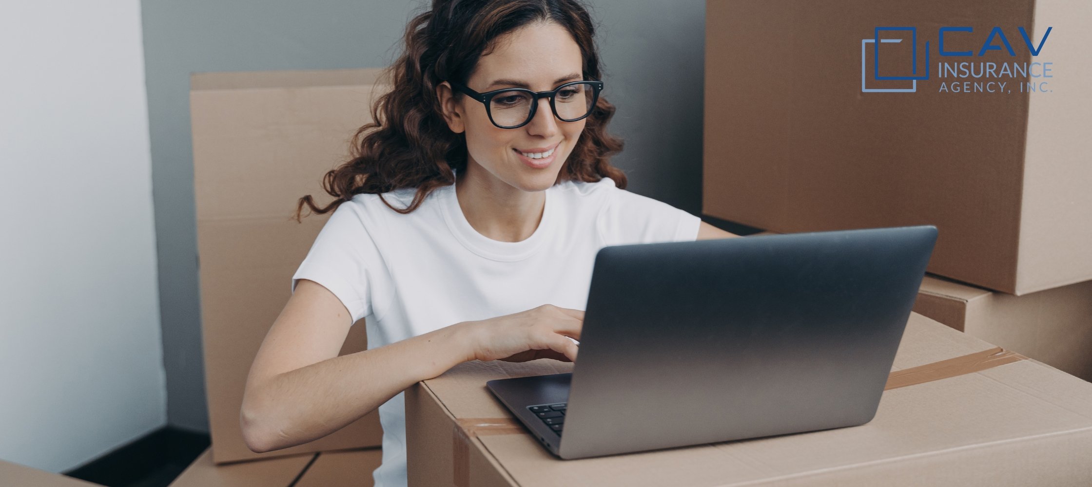 A woman sitting at a table with a laptop.