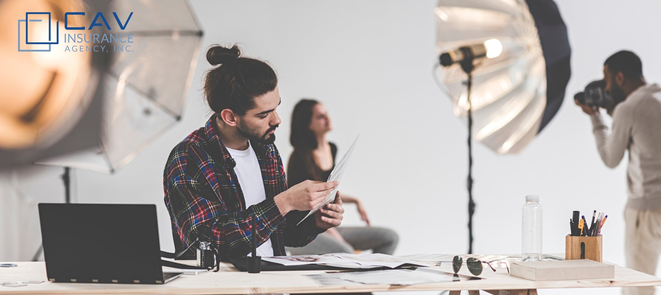 A man sitting at a table with a laptop.