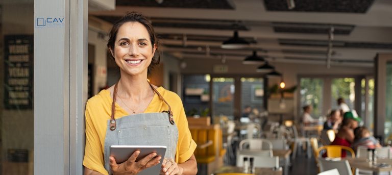 A woman holding an ipad in her hand.